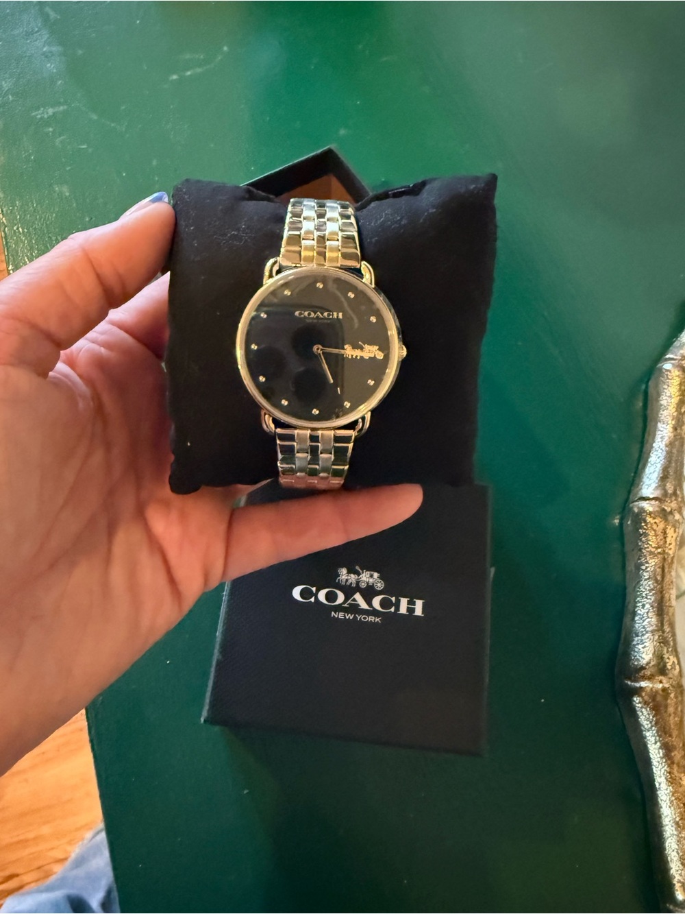 Coach women’s Gold-Tone Bracelet Watch with Black Dial